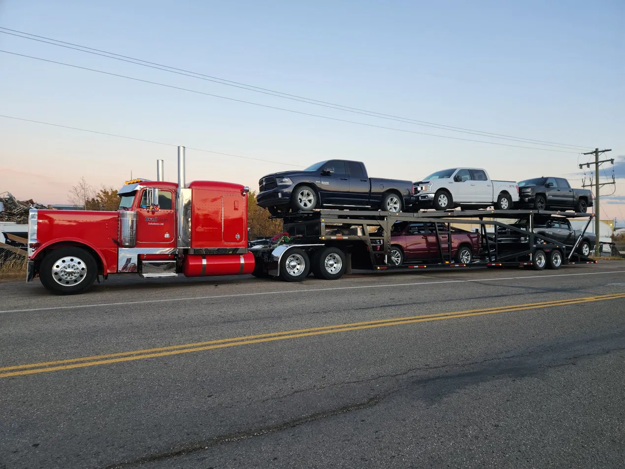 BradLeigh Solutions loaded car hauler at dusk